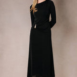 Black maxi dress with a boat neck, long sleeves, and a front ruched buckle detail worn by a model.