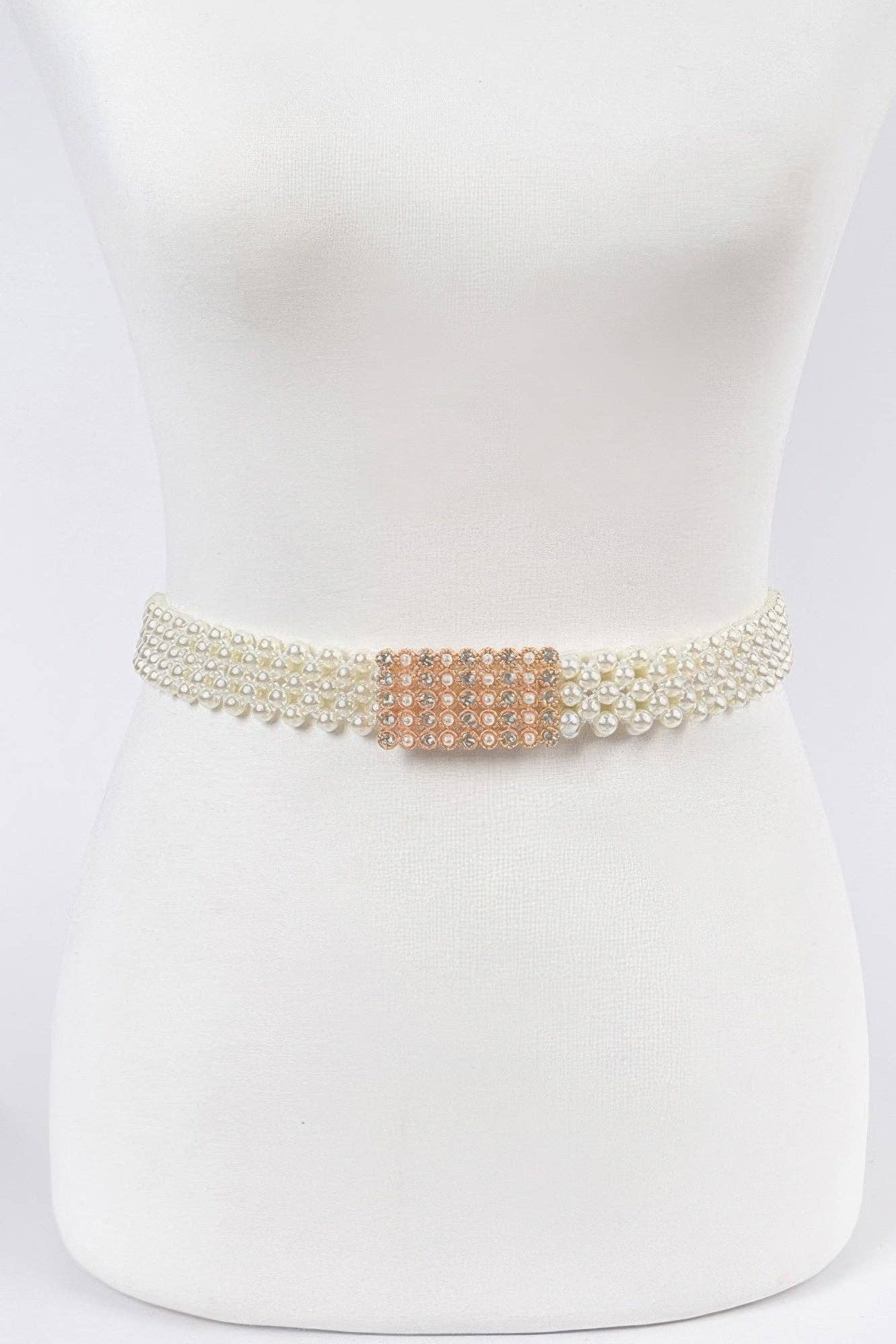 Ivory belt with pearl detailing and a decorative clasp on a mannequin.