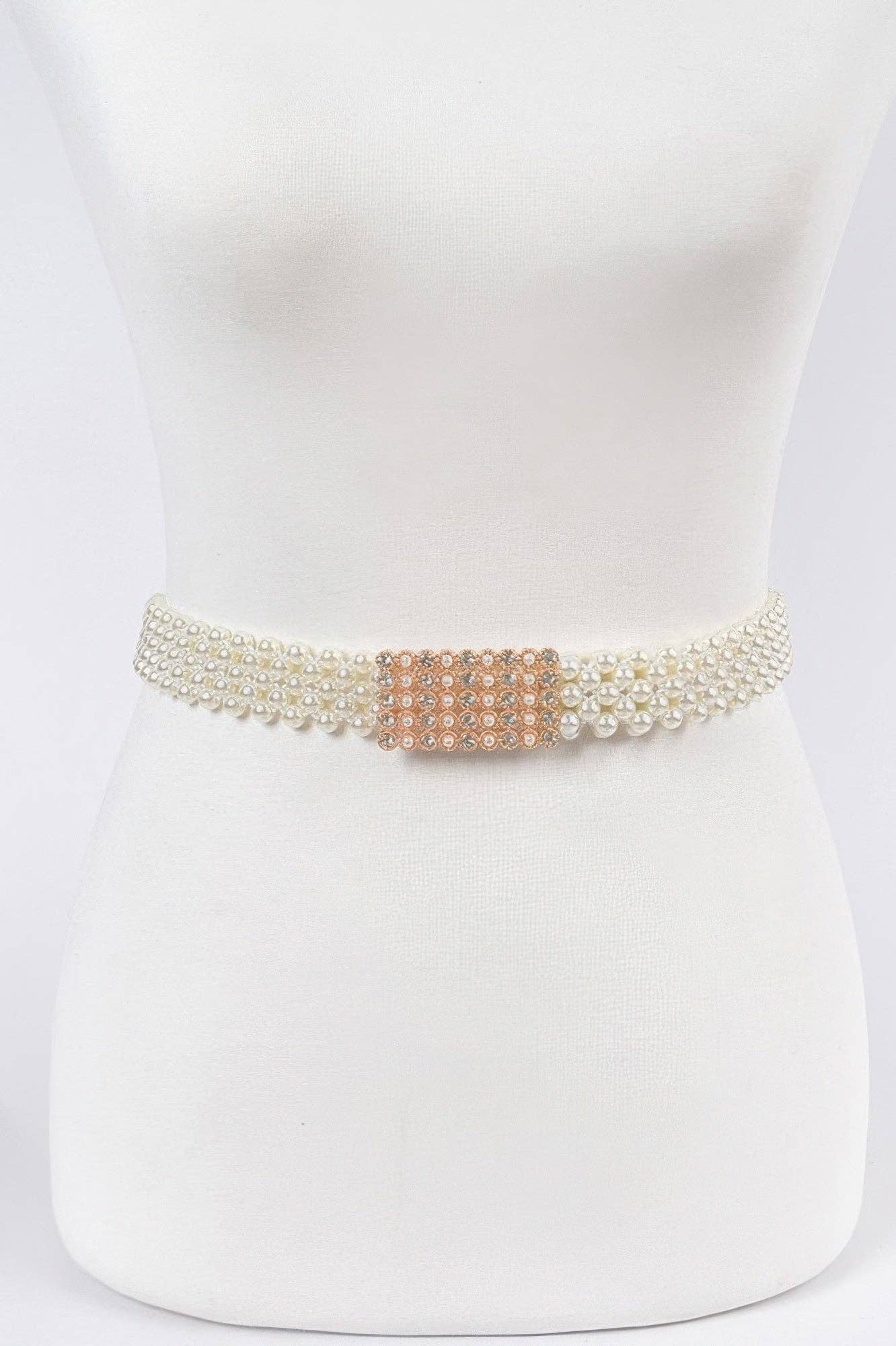 Ivory belt with pearl detailing and a decorative clasp on a mannequin.