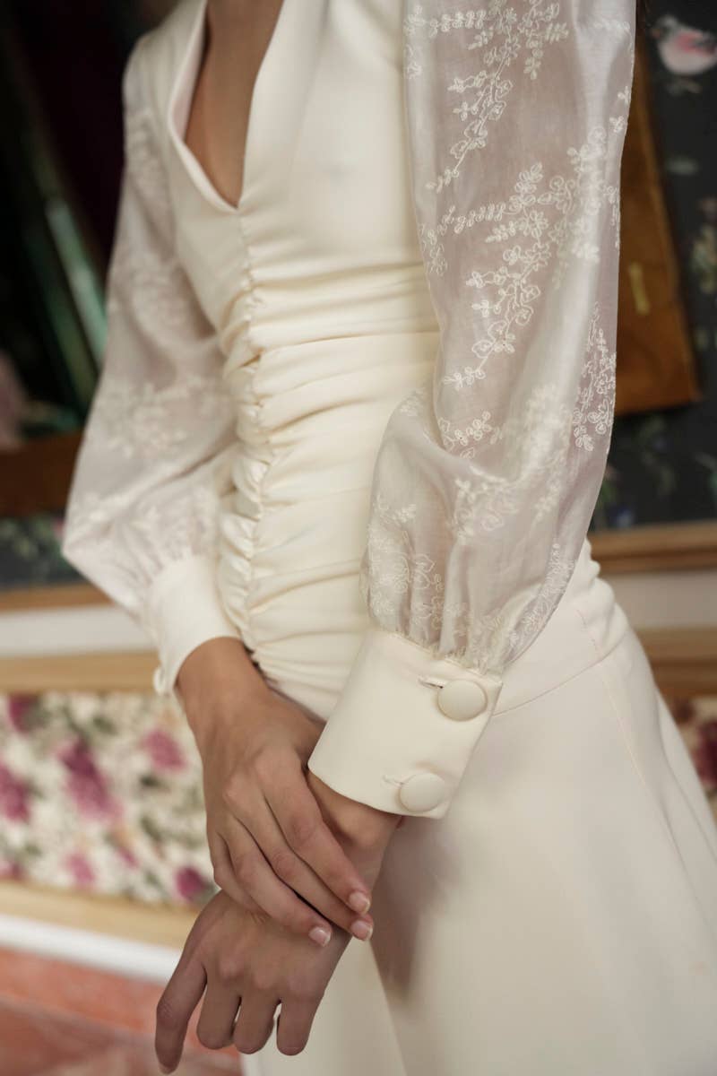 Ivory midi dress with a V-neckline, embroidered voile long sleeves, and a fitted silhouette.