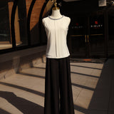 Black chambray palazzo pants with a relaxed fit and long silhouette displayed on a mannequin.