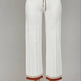 White ribbed knit pants with cognac trim at the waistband and hem, featuring a drawstring waist.